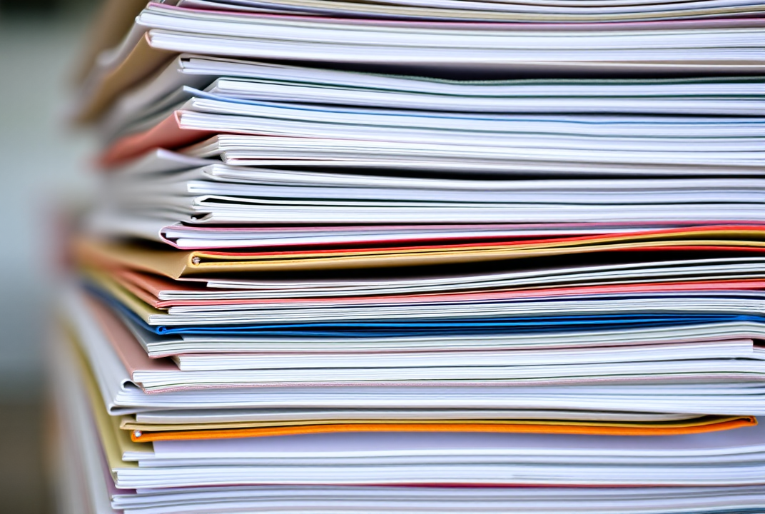 Stacked folders with organized tax documents